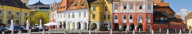 panorama with colorful houses on small square in sibiu, transylvania, romania
